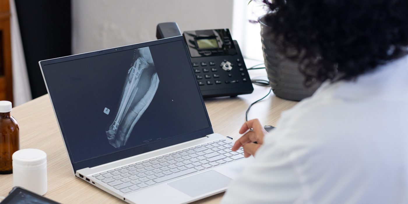 biracial female doctor using laptop with radiograp 2025 04 03 11 56 30 utc scaled