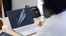 biracial female doctor using laptop with radiograp 2025 04 03 11 56 30 utc scaled