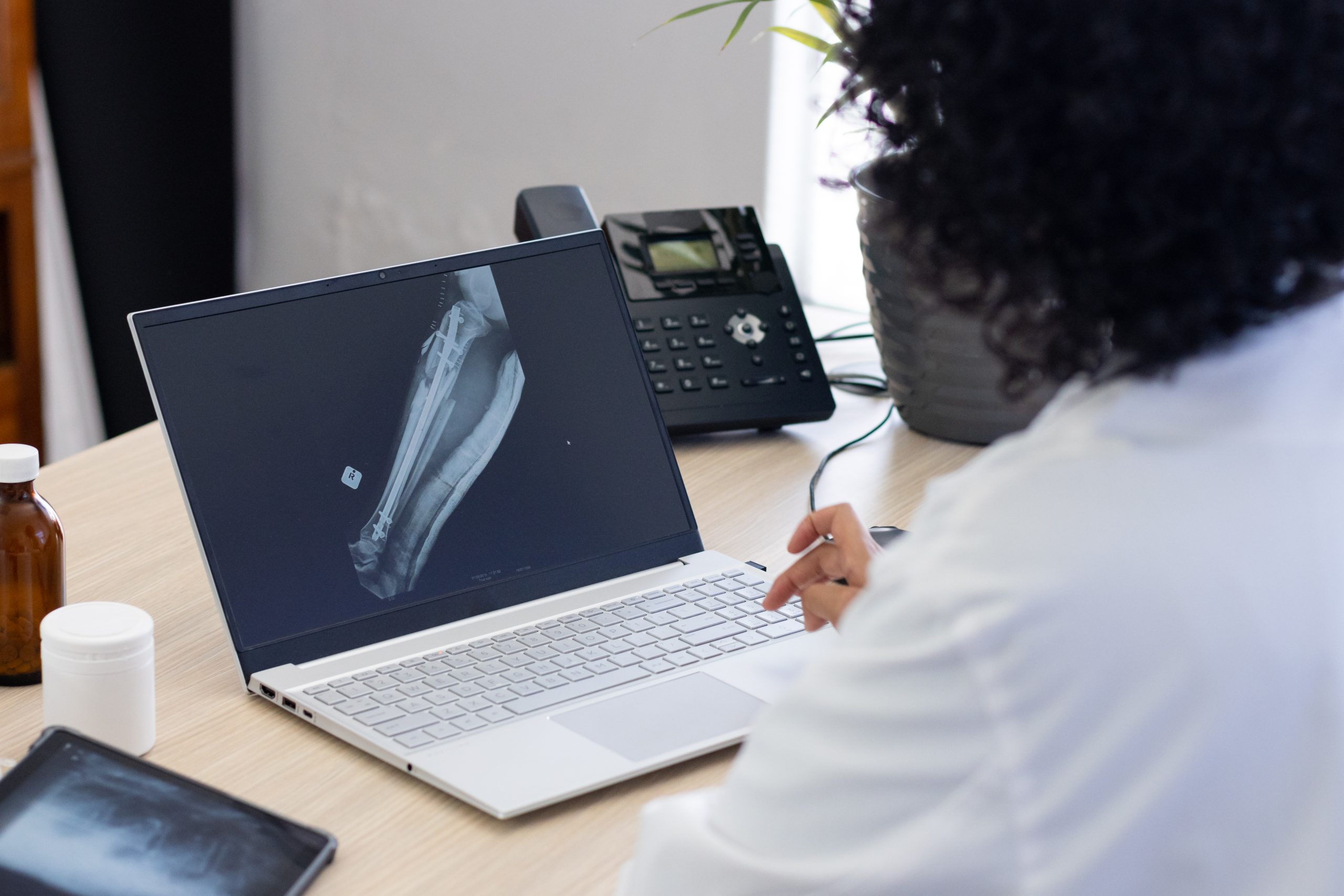 biracial female doctor using laptop with radiograp 2025 04 03 11 56 30 utc scaled